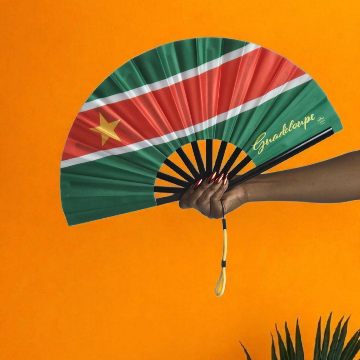 Guadeloupe revolutionary folding fan featuring green top and bottom, red center with white borders, and gold star on the left – cultural accessory by Caribae Kiss