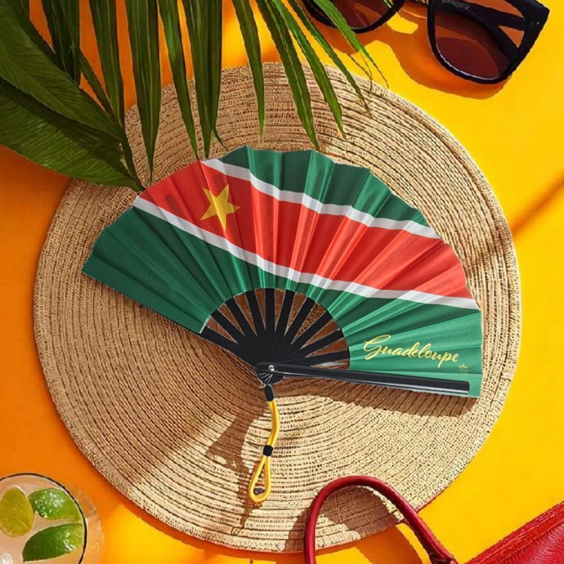 Guadeloupe revolutionary folding fan featuring green top and bottom, red center with white borders, and gold star on the left – cultural accessory by Caribae Kiss