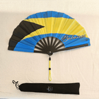 Flat lay of Bahamas flag inspired bamboo folding hand fan along with black suede satchel bag with Caribae Kiss white logo print.