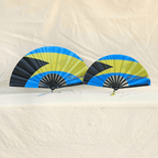 Bahamas flag inspired bamboo folding hand fans of various sizes (large and small) open and standing.