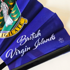 Close up of British Virgin Islands flag inspired bamboo folding hand fan displaying the country's name in script font and displaying the Caribae Kiss logo.