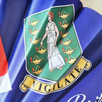 Close up of British Virgin Islands flag inspired bamboo folding hand fan.  Close up of the national emblem of the Saint Ursula