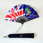 Flat lay of British Virgin Islands flag inspired bamboo folding hand fan along with black suede satchel bag with Caribae Kiss white logo print.