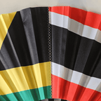 Close up of Dual Heritage Jamaica and Trinidad & Tobago flag inspired bamboo folding hand fan displaying the graft line design that represents two cultures merging into one.