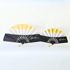 Garifuna flag inspired bamboo folding hand fans of various sizes (large and small) open and standing.