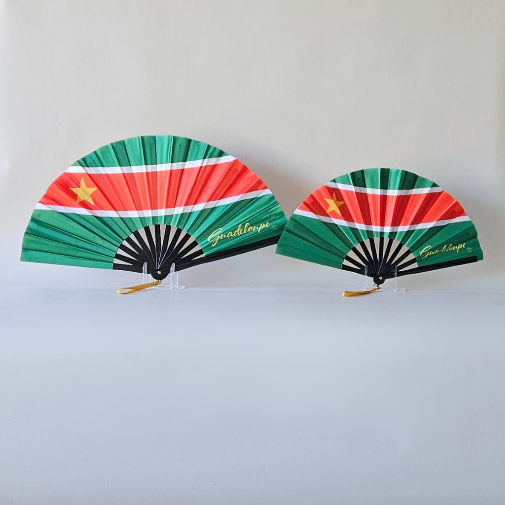 Guadeloupe flag inspired bamboo folding hand fans of various sizes (large and small) open and standing.