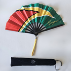 Flat lay of Guyana flag inspired bamboo folding hand fan along with black suede satchel bag with Caribae Kiss white logo print.