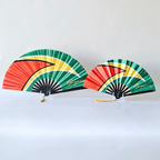 Guyana flag inspired bamboo folding hand fans of various sizes (large and small) open and standing.