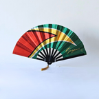 Guyana flag inspired bamboo folding hand fan, open, standing