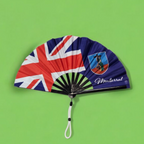Montserrat folding hand fan featuring the Montserrat flag and tassel – cultural accessory by Caribae Kiss for St. Patrick’s Festival and island pride